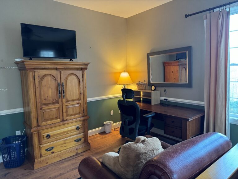 A view of the desk and couch space in the Zafris Room at the A Reason to Write Retreat Space.